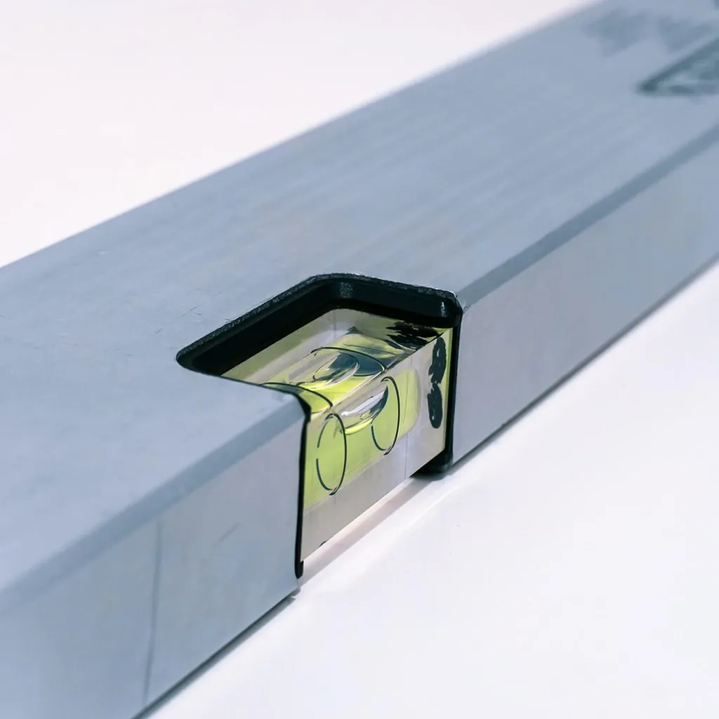 Checking a shelf for level before fixing Close-up of a spirit level with the bubble centred between the two marks.