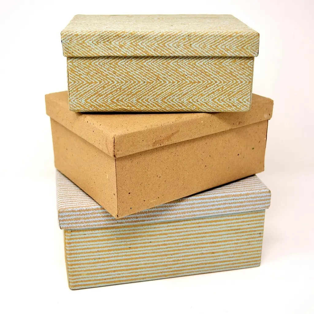 Separate containers for offcuts, dust and true waste Three lidded storage boxes of different sizes stacked neatly on a pale surface.