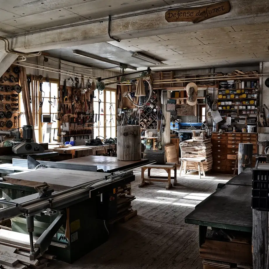 What a dedicated workshop of a few hundred square feet holds A traditional woodworking shop filled with benches, machines and racked timber.