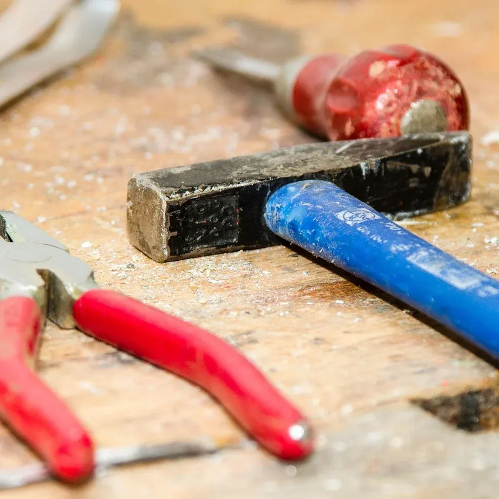 Simple workbench surface Workbench surface holding a hammer, pliers, and other hand tools