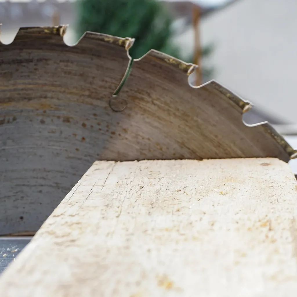 Circular saw and straight edge Circular saw blade exposed while cutting along a straight edge