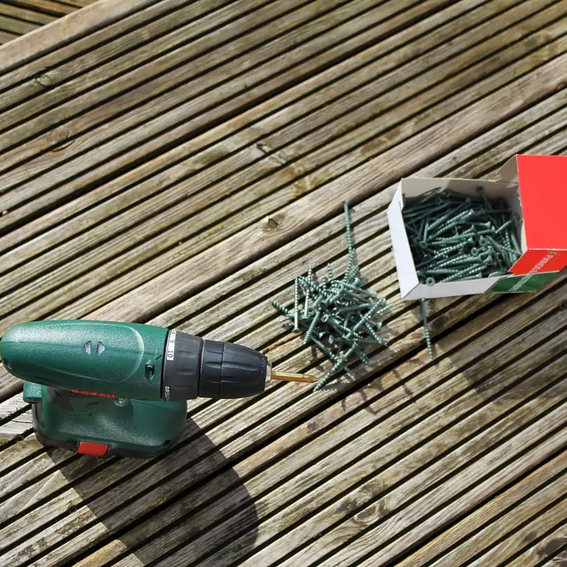 Driving a pocket hole screw Cordless drill driving a screw into a wooden board