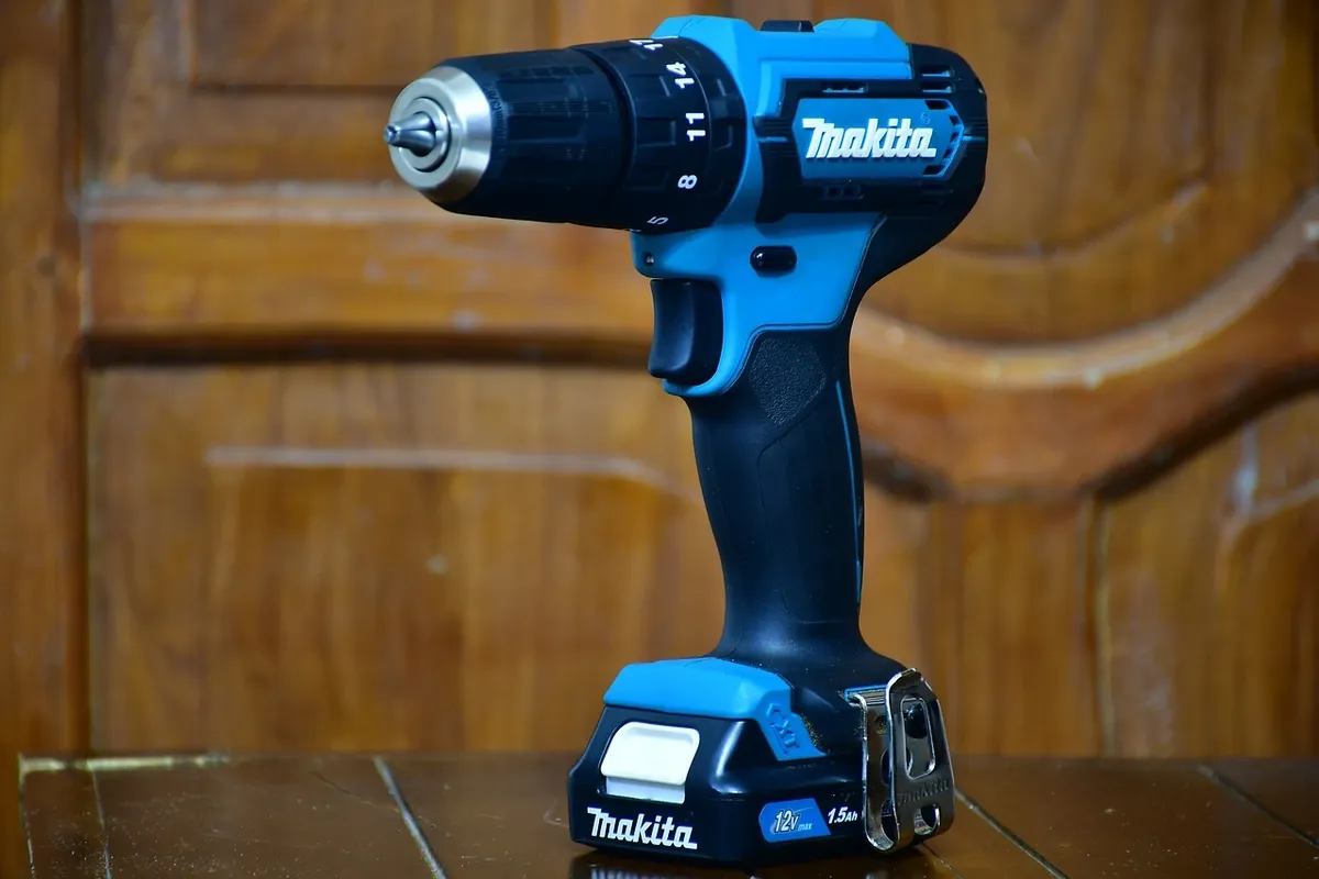 Cordless power drill with battery pack sitting on a workbench