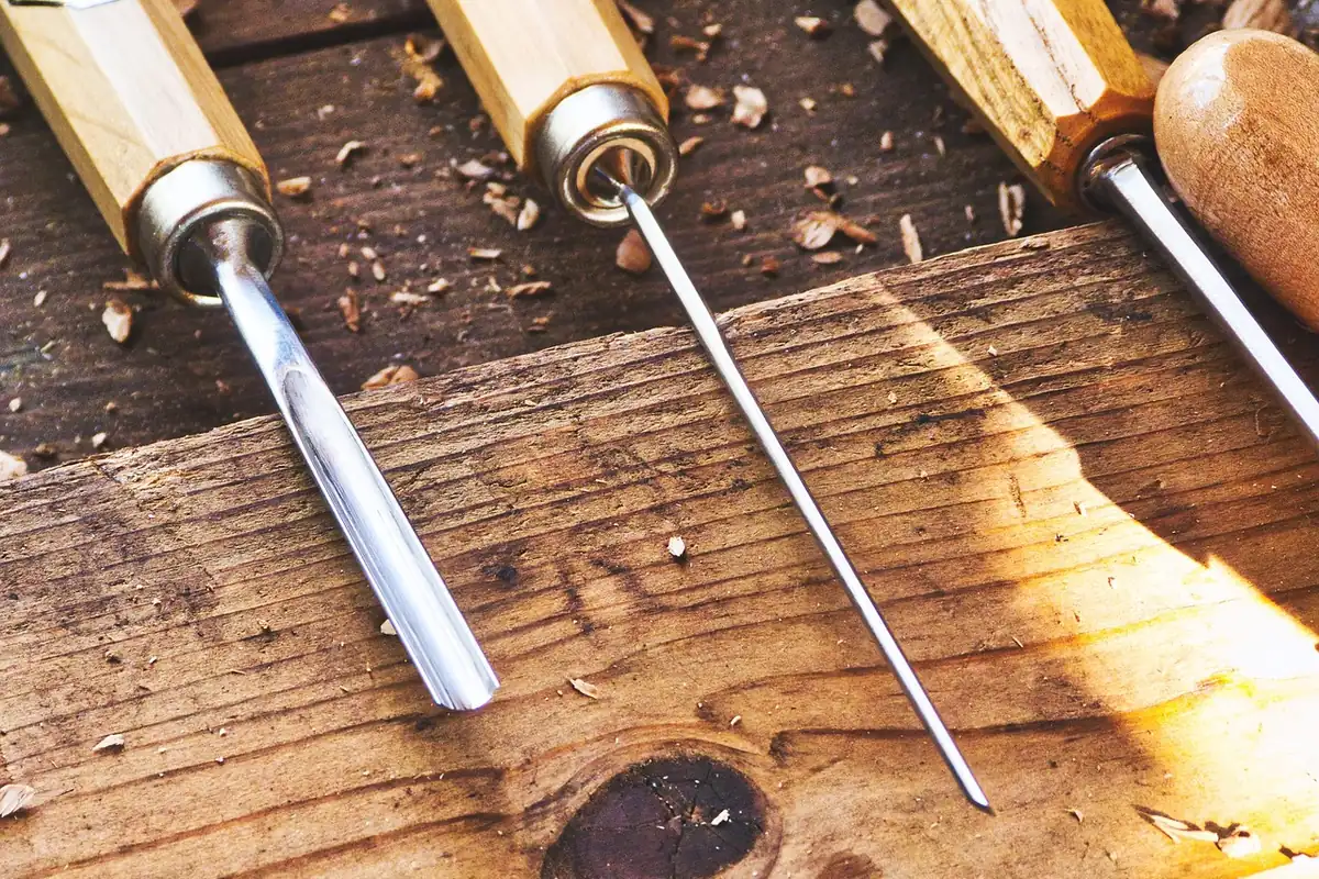 Assorted woodworking hand tools laid out on a workbench