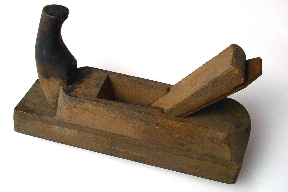 Hand plane sitting on a wooden workbench