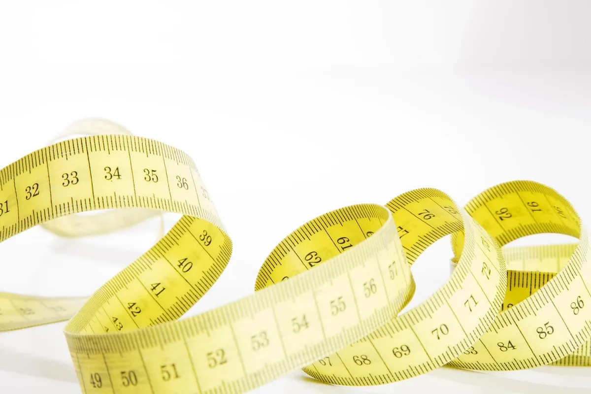 Tape measure extended across a wooden board