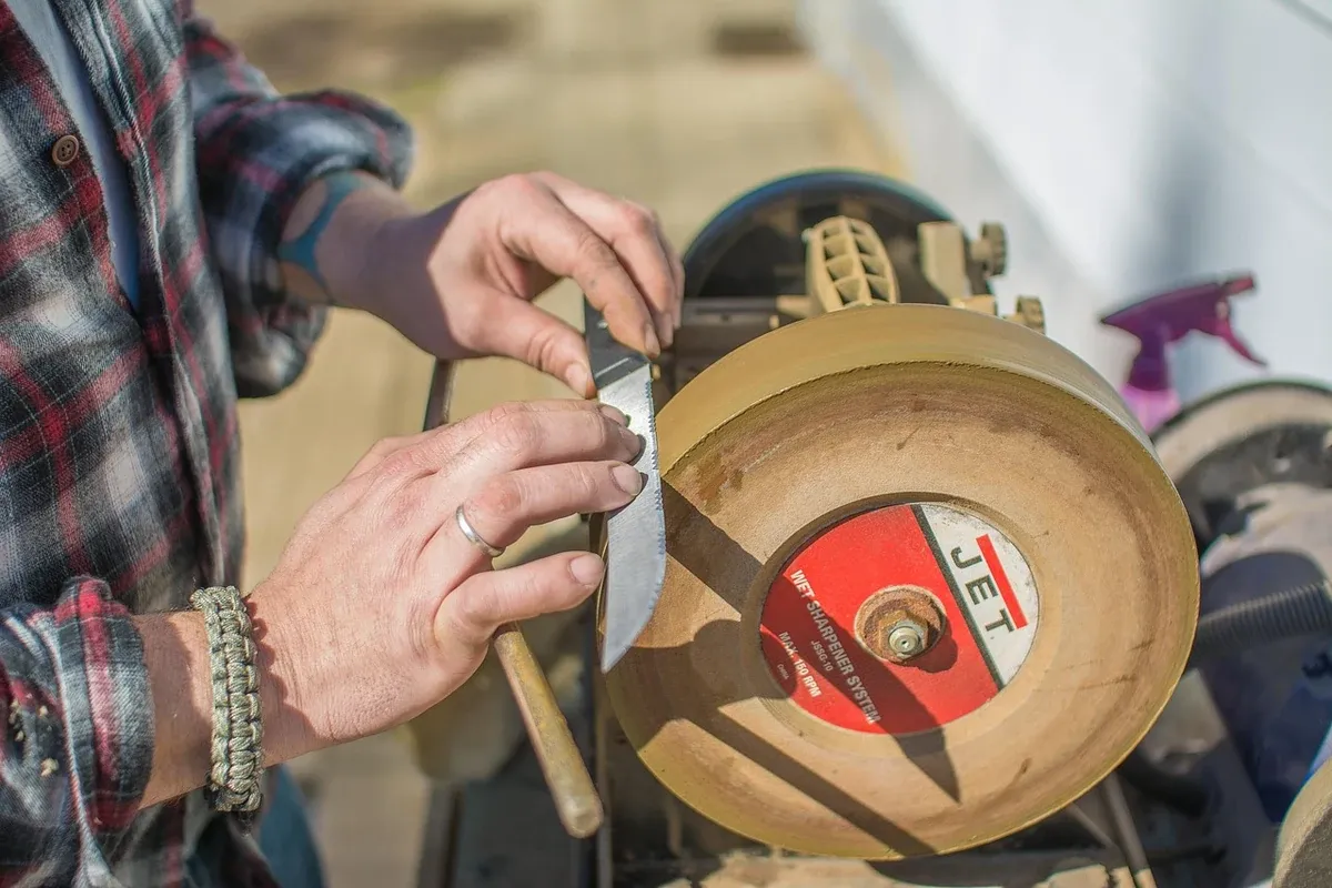 Blade being sharpened against a whetstone