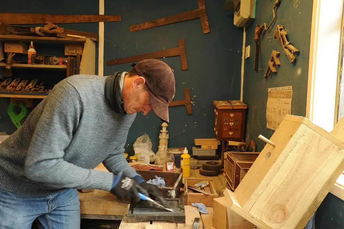 Wood chisel resting among hand tools in a workshop