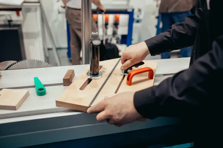 Sliding table saw in a home workshop with a safety guard fitted