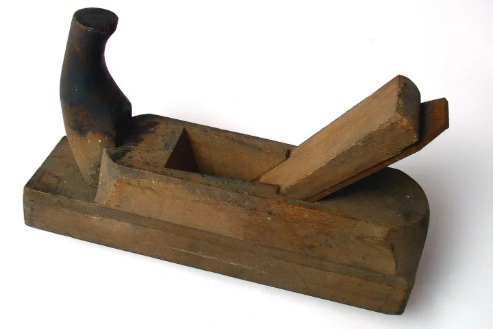 Hand plane sitting on a wooden workbench