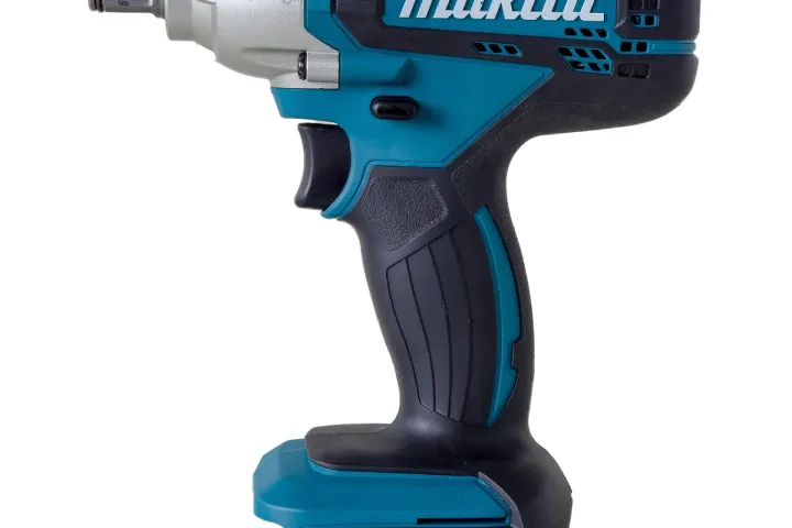 Cordless impact driver with a bit installed, resting on a workbench
